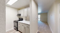 Located at 15723 40th Avenue West in Lynnwood, WA, this well-appointed one-bedroom, one-bathroom unit offers a thoughtfully organized single-floor layout. The combined kitchen and living area anchors the space, with a pass-through countertop in a marble-look finish visually connecting the two zones while maintaining a sense of openness. The kitchen features gray shaker-style cabinetry with ample storage, marble-look countertops, a stainless steel sink, and black appliances including an electric range and refrigerator, complemented by wood-look flooring for easy maintenance. The living area is finished with plush carpet and includes a ceiling fan with integrated lighting, contributing to a comfortable, functional environment. A sliding glass door brings in natural light and provides outdoor access. The bedroom is a well-proportioned retreat with carpet flooring, a window with a view of surrounding greenery, and neutral walls that offer a calm ambiance. A dedicated closet adds practical storage. The full bathroom is clean and modern, featuring a tub-shower combination, a vanity with a marble-look countertop, updated brushed-nickel fixtures, and wood-look flooring. The overall design emphasizes clean lines, neutral tones, and efficient use of space throughout.