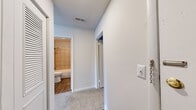 Located at 5840 Lake Resort Terrace in Chattanooga, Tennessee, this single-floor unit offers a well-organized layout designed for comfortable living. The spacious main living area is finished with neutral wall-to-wall carpeting and features a ceiling fan with a light fixture, providing both comfort and functionality. A large sliding glass door opens onto a private balcony that frames stunning views of the surrounding lake and lush hillside — a standout feature of this residence.

The galley-style kitchen is efficiently designed with white cabinetry, dark granite-style countertops, wood-look flooring, and a full suite of stainless steel and black appliances including a refrigerator, range, and dishwasher, along with a stainless steel sink.

The unit includes multiple carpeted bedrooms, each with ceiling fixtures and ample wall space. A connecting hallway leads to the bathroom, which is outfitted with wood-look tile flooring, a tiled shower and tub surround in a neutral palette, a white vanity, and dark countertops.

Throughout, the unit maintains a clean, neutral aesthetic with white walls, consistent trim work, and ceiling-mounted HVAC vents. A chain door lock at the entry adds an additional layer of security. The overall ambiance is bright, functional, and well-suited to those seeking lakeside living in Chattanooga.
