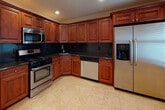 Located at 835 Broadway Ave in Holbrook, NY, this single-floor property offers a thoughtfully designed layout with a cohesive aesthetic throughout. The open living and dining areas are finished with neutral-toned carpeting and accented by elegant crown molding that runs throughout the space. Recessed lighting and classic chandelier fixtures provide layered illumination, while ceiling fans in multiple rooms enhance comfort. Large windows fitted with blinds allow natural light to flow in and offer views of the surrounding neighborhood.

The bedrooms are carpeted and well-proportioned, each featuring crown molding, ceiling fans with integrated lighting, and windows that bring in natural light. The rooms offer a clean, move-in-ready atmosphere.

The kitchen is a standout feature, showcasing rich cherry wood cabinetry, dark granite countertops, a deep tile backsplash, and a full suite of stainless steel appliances including a gas range, built-in microwave, dishwasher, and refrigerator. Light tile flooring completes the space.

Two full bathrooms are finished with dark granite vanity tops, warm cherry wood cabinetry, and white tile work. One bathroom includes a walk-in glass-door shower, while the other features a tiled shower-tub combination with sliding glass doors. Both are clean and functional in design.