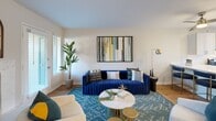 Located in Portland, Oregon, this single-floor, 2-bedroom, 2-bathroom residence offers a thoughtfully designed layout that maximizes every inch of its comfortable footprint. Warm hardwood-style flooring flows throughout the main living areas, beginning at the welcoming entrance and continuing down a well-lit hallway that connects the home's key spaces.

The living room serves as the heart of the home, featuring a classic fireplace with an arched inset surround, a ceiling fan, and a door providing direct access to the private patio. Natural light streams in through window blinds, creating a bright and airy atmosphere.

The kitchen is efficiently designed with white shaker cabinetry, crisp white countertops, stainless steel appliances including a dishwasher, and a window above the sink that brings in additional natural light. A pass-through counter opens directly to the living area, enhancing the sense of connection between spaces.

Both bedrooms offer a cozy retreat, with the primary bedroom showcasing a bold accent wall, a walk-in closet, and a window with outdoor views. Each bathroom is clean and functional, featuring a shower/tub combination. The home also includes four closets and an in-unit laundry area, providing ample storage throughout.