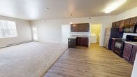 This well-designed apartment in West Fargo offers 1,110 square feet of comfortable living space on a single floor. The layout includes two bedrooms, three full bathrooms, and an open-concept living area. The heart of the home is a modern kitchen equipped with dark wood cabinetry, granite countertops, and stainless steel appliances. The living room seamlessly connects to the kitchen, creating an ideal space for entertaining.

The primary bedroom is a generous 180 square feet, providing ample space for relaxation. Both bedrooms feature plush carpeting and large windows that allow natural light to flood the rooms. The three bathrooms are outfitted with contemporary fixtures, including vanities with granite countertops.

Throughout the apartment, you'll find a mix of flooring types, with durable wood-look laminate in the kitchen and living areas, and soft carpeting in the bedrooms. The neutral color palette provides a blank canvas for personal decorating styles. Additional amenities include in-unit laundry facilities and multiple closets for storage. Large windows in every room offer views of the surrounding area and fill the space with natural light, enhancing the overall sense of spaciousness in this well-appointed apartment.