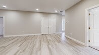 Located at 151 Hope Dr in Winchester, Virginia, this single-floor, 2-bedroom, 2-bathroom home offers a clean, modern aesthetic with a thoughtfully designed open layout. The heart of the home is a combined living, dining, and kitchen area that flows seamlessly, creating a bright and spacious atmosphere. Light wood-look flooring runs throughout the main living spaces, complementing the neutral gray-toned walls and recessed lighting overhead.

The kitchen is a standout feature, equipped with crisp white shaker-style cabinetry, granite countertops, stainless steel appliances, and a central island with pendant lighting above — ideal for both cooking and casual dining. A dedicated pantry provides additional storage.

The primary bedroom is generously sized, featuring soft carpeting and a double closet. The second bedroom is also carpeted and includes two closets for ample storage. Both bathrooms are finished with white cabinetry, clean countertops, and light flooring that mirrors the rest of the home.

Additional highlights include a dedicated laundry room, a central hallway connecting all rooms, and four closets spread throughout the home. The overall design is modern and move-in ready, with a cohesive neutral palette that lends a bright, welcoming ambiance throughout.