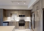 Located at 4200 NW 107 Ave in Doral, Florida, this single-floor residence offers a thoughtfully designed open-concept layout finished with contemporary touches throughout. Light wood-look flooring runs seamlessly across the living areas, creating a bright and cohesive aesthetic.

The kitchen is a standout feature, showcasing rich wood-toned cabinetry extending to the ceiling for ample storage, complemented by crisp white quartz countertops and a geometric patterned tile backsplash. A full suite of stainless steel appliances — including a refrigerator, electric range with over-the-range microwave, and dishwasher — complete the space. A central kitchen island with pendant lighting above provides additional counter space and serves as a natural gathering point that flows into the open living area.

The bathroom is outfitted with clean white subway tile surrounding a full soaking tub and shower combination, wood-look tile flooring, and recessed lighting, delivering a fresh and functional design. The living areas feature neutral walls and generous natural light, offering a versatile canvas for any style.

A dedicated in-unit laundry closet houses a stacked Whirlpool washer and dryer, adding everyday convenience. The overall design balances modern finishes with practical functionality, making this Doral residence a well-appointed space.