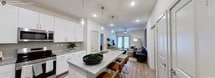 This contemporary 910 square foot apartment in Farmersville, Texas, offers a harmonious blend of style and functionality. The space features two bedrooms and two bathrooms, with the primary bedroom boasting a generous 160 square feet. The open-concept design creates a seamless flow between the living room and kitchen, enhancing the sense of spaciousness.

The kitchen is a highlight, featuring crisp white cabinetry, stainless steel appliances, and a striking granite-topped island that doubles as a breakfast bar. Pendant lighting adds a touch of elegance, while the wood-look flooring throughout provides warmth and durability.

Both bedrooms are well-appointed, with plush carpeting and ample natural light. The bathrooms showcase modern fixtures, including glass-enclosed showers and granite countertops. Generous closet space in both bedrooms and throughout the apartment ensures plenty of storage.

The living area is perfect for relaxation and entertainment, with large windows that flood the space with natural light. Thoughtful design elements, such as ceiling fans and contemporary light fixtures, add both comfort and style.

Overall, this apartment combines modern aesthetics with practical living, offering a comfortable and stylish home in the heart of Farmersville.