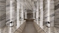 Located at 1020 N Tyndall Ave in Tucson, Arizona, this meticulously designed spa or steam room space delivers an immersive, luxurious experience through its bold and cohesive material palette. The single room is enveloped from floor to ceiling in dramatic veined marble slabs in tones of grey, white, and charcoal, creating a sense of grandeur that belies the room's intimate footprint. Vertical LED light strips are evenly spaced along the marble-clad walls, casting a soft, luminous glow that accentuates the natural movement of the stone and amplifies the sense of depth within the space. The flooring and raised platform seating feature detailed geometric patterned encaustic-style tiles in earthy brown and cream tones, providing a striking visual contrast to the polished marble surfaces above. The central raised platform runs the length of the room, flanked by decorative lanterns that add a warm, ambient accent. A wood-paneled sauna enclosure is visible in one corner, offering an additional wellness element. The space is accessed through a dark-paneled door and is designed with a clean, symmetrical layout that enhances its spa-like serenity. Every detail, from the reflective marble surfaces to the carefully coordinated tilework, contributes to an atmosphere of refined elegance and tranquil retreat.