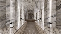 Located at 1020 N Tyndall Ave in Tucson, Arizona, this meticulously designed spa or steam room space delivers an immersive, luxurious experience through its bold and cohesive material palette. The single room is enveloped from floor to ceiling in dramatic veined marble slabs in tones of grey, white, and charcoal, creating a sense of grandeur that belies the room's intimate footprint. Vertical LED light strips are evenly spaced along the marble-clad walls, casting a soft, luminous glow that accentuates the natural movement of the stone and amplifies the sense of depth within the space. The flooring and raised platform seating feature detailed geometric patterned encaustic-style tiles in earthy brown and cream tones, providing a striking visual contrast to the polished marble surfaces above. The central raised platform runs the length of the room, flanked by decorative lanterns that add a warm, ambient accent. A wood-paneled sauna enclosure is visible in one corner, offering an additional wellness element. The space is accessed through a dark-paneled door and is designed with a clean, symmetrical layout that enhances its spa-like serenity. Every detail, from the reflective marble surfaces to the carefully coordinated tilework, contributes to an atmosphere of refined elegance and tranquil retreat.