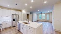 Located at 190 Moll Dr in Santa Rosa Beach, FL, this well-appointed single-story home offers four bedrooms and three bathrooms within a thoughtfully designed open floor plan. The heart of the home is a bright, modern kitchen featuring white shaker cabinetry, quartz countertops, a center island with an undermount sink, and stainless steel appliances including a range, microwave, and refrigerator. The kitchen flows seamlessly into the living area, which is bathed in natural light from multiple windows and topped with a ceiling fan for year-round comfort. Wood-look flooring runs throughout the home, lending a warm, cohesive aesthetic. The bedrooms are bright and airy, each with natural light streaming through blinds-fitted windows, ceiling fans, and generous closet space. The closets are equipped with wire shelving systems for efficient organization. The bathrooms are finished to a high standard, with at least one featuring a sleek walk-in glass-enclosed shower adorned with large-format tile and brushed nickel fixtures. A dedicated laundry area houses a full-size washer and dryer. The clean, neutral palette and modern finishes throughout create a fresh, move-in-ready living environment ideal for comfortable coastal living.