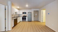 Located at 59th Ave N in Plymouth, Minnesota, this single-floor residence offers a clean, modern aesthetic with a thoughtfully designed open-concept layout. Light-toned luxury vinyl plank flooring runs throughout the space, creating a cohesive and contemporary feel.

The kitchen is a functional centerpiece, outfitted with crisp white cabinetry, granite countertops, a stainless steel dishwasher, refrigerator, range, and microwave. The open connection to the living area makes the kitchen ideal for both everyday use and entertaining.

The living area is bright and spacious, benefiting from natural light and a neutral color palette that provides a versatile backdrop for any furnishing style. Bedroom spaces continue the light-filled theme, each featuring windows with blinds and curtains that allow for adjustable natural light.

The bathrooms are finished with granite-topped white vanities, large mirrors, modern brushed-nickel hardware, and light wood-tone flooring, reflecting the same refined simplicity found throughout the residence.

Overall, this residence presents a well-maintained, move-in-ready interior with consistent modern finishes, ample natural light, and a practical single-level floor plan well-suited to comfortable everyday living in the Plymouth, MN area.