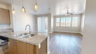 This contemporary townhouse in Las Vegas offers 1230 square feet of well-designed living space spread across two floors. The property features 2 bedrooms and 4 bathrooms, providing ample space and privacy for residents and guests. The primary bedroom is generously sized at 180 square feet.

The home's open-concept design is evident in the combined kitchen and living room area. The kitchen boasts modern amenities, including stainless steel appliances, sleek cabinetry, and a central island with pendant lighting. The living area seamlessly connects to the kitchen, creating an ideal space for entertaining.

Throughout the home, large windows and sliding glass doors allow for abundant natural light, enhancing the sense of spaciousness. The flooring varies between rooms, with stylish wood-look planks in the main living areas and plush carpeting in the bedrooms.

The laundry room is equipped with full-sized washer and dryer units, while the bathrooms feature contemporary fixtures and finishes. Ample storage space is provided through built-in closets and additional storage areas.

The property's location at 12020 Southern Highlands Parkway offers convenient access to local amenities while maintaining a residential feel. With its modern design and thoughtful layout, this townhouse presents an attractive option for those seeking a contemporary living space in Las Vegas.