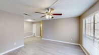 Located at 1100 Willow Springs Rd in Killeen, Texas, this single-story 2-bedroom, 1-bathroom home offers a practical and well-organized layout. Throughout the home, light wood-style flooring and neutral warm-gray walls create a clean, cohesive aesthetic, while textured ceilings and ceiling fans with integrated light fixtures are found in every room.

The living room serves as the central gathering space, featuring a large window with blinds that allows natural light to fill the room, along with a dedicated entryway door. The kitchen is equipped with white cabinetry, laminate countertops, and includes a refrigerator and range, providing ample storage and prep space.

Both bedrooms are well-sized, each featuring a ceiling fan, windows with blinds for natural light, and access to closet storage. The primary bedroom includes a built-in closet with a hanging rod, accessed via bifold doors. The single full bathroom offers a tub-shower combination with tile surround, a vanity with countertop, and matching flooring consistent with the rest of the home.

Two hallways connect the rooms efficiently, and a dedicated closet provides additional storage. The home's consistent finishes and functional room arrangement make it a straightforward, move-in ready space in Killeen, TX.