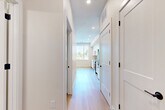 Located at 4225 E Hale Pkwy in Denver's desirable Park Hill neighborhood, this well-designed one-bedroom, one-bathroom unit offers a clean, modern aesthetic across its efficiently planned single floor. Light-toned hardwood flooring runs throughout, creating a bright and cohesive feel from room to room.

The open-concept living, dining, and kitchen area serves as the heart of the unit. The kitchen is appointed with sleek flat-front white cabinetry extending to the ceiling, a herringbone-patterned tile backsplash, stainless steel appliances including a dishwasher, range, and built-in microwave, and a single-basin sink. A large window floods the dining area with natural light and offers pleasant views of the surrounding tree-lined neighborhood.

A well-organized hallway connects the living areas to the private spaces, lined with shaker-style doors featuring matte black hardware that provide access to closets, a pantry, and an in-unit laundry area. The bedroom is a comfortable, quiet retreat with light-filled windows, light wood floors, and a double-door closet with matching shaker styling.

The bathroom features large-format neutral tile on both the floor and tub surround, a soaking tub with overhead shower, and a clean white vanity, delivering a calm and functional space.
