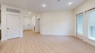 Located at 3311 Hood Ave in Chamblee, GA, this thoughtfully designed 2-bedroom, 2-bathroom residence offers a clean, modern aesthetic throughout its single-floor layout. The entrance hallway, featuring recessed lighting and light-toned hardwood-style flooring, leads into a spacious open-concept area combining the living room, dining room, and kitchen. The kitchen is outfitted with gray shaker-style cabinetry, white countertops, a stainless steel appliance, and black hardware accents, providing ample storage and a contemporary finish. The living area continues the light flooring and neutral palette, creating a bright, airy atmosphere. Both bedrooms are carpeted and include ceiling fans, natural light from windows, and access to closets — with the primary bedroom offering a notably generous footprint and a walk-in closet with wire shelving systems. The two bathrooms are clean and modern, one featuring a glass-enclosed walk-in shower with white subway tile and gray vanity cabinetry. A dedicated in-unit laundry area accommodates a full-size washer and dryer. The private patio opens to views of the surrounding community. With four total closets throughout, storage is plentiful, and the overall design emphasizes functionality and modern style.