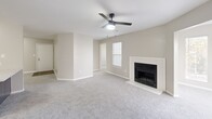 Located at 100 Bryton Trce in Columbia, SC, this single-floor, 2-bedroom, 2-bathroom home offers a comfortable and functional layout. The spacious living room is a standout feature, centered around a classic fireplace with a white surround and complemented by soft carpeting and a ceiling fan with integrated lighting. Large windows allow natural light to fill the room, creating a bright and welcoming atmosphere. The open-concept kitchen-living area flows seamlessly, with the kitchen showcasing gray cabinetry, stainless steel appliances, a double-basin sink, and a marble-style countertop peninsula that provides additional workspace and casual seating. Wood-look flooring adds warmth to the kitchen area. Both bedrooms are carpeted and finished in neutral tones, offering a calm retreat. The primary bedroom provides a generous footprint with access to a closet. The second bedroom features a built-in closet and a large window with views of lush greenery. The bathrooms are clean and functional, with one featuring a white vanity, large mirror, and wood-look flooring. Additional highlights include two closets, a dedicated laundry area with washer/dryer hookups, and a wire shelving system for organized storage.