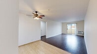 Located at 750 Carondolet in the heart of Los Angeles, this 2-bedroom, 2-bathroom residence offers a well-designed single-floor layout with a clean, modern aesthetic throughout. The open living area is finished with dark hardwood flooring and features a ceiling fan with light fixture, complemented by neutral white walls that create a bright and airy atmosphere. Sliding glass doors lead to a private balcony, framing impressive views of the Los Angeles city skyline — a standout feature of the space. The galley-style kitchen is efficiently arranged with rich, dark wood cabinetry, ample upper and lower storage, a double-basin sink, and a gas range, all set atop light tile flooring. Both bedrooms are generously proportioned, featuring the same dark hardwood floors, large windows with vertical blinds allowing natural light, and sliding-door closets for organized storage. The primary bedroom benefits from its own access to natural light and closet space. Both bathrooms are finished in a crisp white palette, each featuring a tub-shower combination, white cabinetry, tile flooring, and a window for ventilation. A connecting hallway ties the layout together, making for a functional and cohesive living experience in a vibrant urban setting.