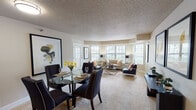 Located at 8601 Edinbrook Crossing in Brooklyn Park, Minnesota, this single-floor residence offers a thoughtfully designed layout with a seamless flow between living spaces. The open-concept living and dining area is bright and welcoming, featuring plush carpeting, a textured ceiling, and a generous arrangement of windows dressed with horizontal blinds that invite abundant natural light and views of the surrounding greenery. A patio door in the dining area provides easy outdoor access, enhancing the sense of openness.

The kitchen is well-equipped, showcasing rich dark cabinetry, granite-style countertops, warm hardwood-style flooring, and a full suite of stainless steel appliances including a range, microwave, and dishwasher. A peninsula counter adds additional prep space and a convenient breakfast bar option.

The bedroom is carpeted and cozy, benefiting from natural light through a large window. A versatile den offers space for a home office or additional sleeping area, complete with its own window and ample room for flexible use.

The primary bathroom features a granite-topped vanity, dark cabinetry, a tub-shower combination, and a convenient in-unit washer and dryer. A second bathroom provides a glass-enclosed shower stall. Together, these spaces combine practical functionality with a polished, contemporary aesthetic.