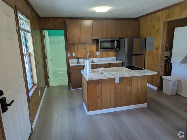 Kitchen with island, microwave, fridge, 2 burner stovetop. - 108 Business Park Cir