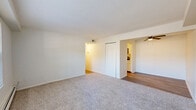 Located at 3289 Rocker Dr in Cincinnati, OH, this single-floor, 1-bedroom, 2-bathroom unit offers a clean, functional layout designed for comfortable everyday living. The kitchen stands out with crisp white cabinetry, marble-look countertops, and light wood-style flooring, lending a modern, refreshed feel to the space. A stainless steel dishwasher adds a practical touch to the well-organized galley-style kitchen. The living room is bright and welcoming, featuring plush carpeting, a large window that brings in natural light and outdoor views of surrounding greenery, and a baseboard heating system. The bedroom is comfortably sized, also carpeted, and benefits from natural light via a generously proportioned window. It includes a sliding closet as well as additional door access, offering useful storage options. Two bathrooms serve the unit, one of which features a full tub-shower combo with clean white surround and chrome fixtures. A connecting hallway ties the layout together efficiently. Throughout the unit, a neutral white and beige color palette creates a bright, airy ambiance, making the space feel open and easy to personalize.