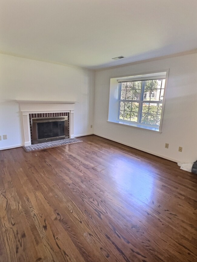 Living room with fireplace and picture window - 69 Court Pl