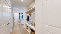 Located in Savannah, GA, this thoughtfully designed one-bedroom, one-bathroom residence offers a functional and stylish layout across a single floor. Light-toned wood-look flooring flows through the main living areas, complementing a bright, neutral color palette throughout.

The open-concept kitchen and living room serves as the heart of the home. The kitchen features white shaker cabinetry, granite countertops, a subway tile backsplash, a central island with bar seating, stainless steel appliances, and pendant lighting overhead. The living area is filled with natural light from multiple windows dressed in classic blinds and navy curtains, with direct access to an exterior door.

A standout feature is the built-in mudroom/entryway, complete with shiplap-style paneling, open shelving, hooks, and cubbies — offering excellent organization upon entry.

The bedroom is a comfortable retreat with plush carpet, large windows allowing ample natural light, and a dedicated closet. The full bathroom includes a tub-shower combination with tile surround and wood-look flooring.

A hallway connects the spaces efficiently, rounding out a well-appointed layout ideal for modern single-occupant living in the heart of Savannah.