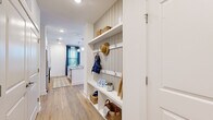 Located in Savannah, GA, this thoughtfully designed one-bedroom, one-bathroom residence offers a functional and stylish layout across a single floor. Light-toned wood-look flooring flows through the main living areas, complementing a bright, neutral color palette throughout.

The open-concept kitchen and living room serves as the heart of the home. The kitchen features white shaker cabinetry, granite countertops, a subway tile backsplash, a central island with bar seating, stainless steel appliances, and pendant lighting overhead. The living area is filled with natural light from multiple windows dressed in classic blinds and navy curtains, with direct access to an exterior door.

A standout feature is the built-in mudroom/entryway, complete with shiplap-style paneling, open shelving, hooks, and cubbies — offering excellent organization upon entry.

The bedroom is a comfortable retreat with plush carpet, large windows allowing ample natural light, and a dedicated closet. The full bathroom includes a tub-shower combination with tile surround and wood-look flooring.

A hallway connects the spaces efficiently, rounding out a well-appointed layout ideal for modern single-occupant living in the heart of Savannah.