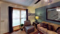 Located at 3402 Leah Ct NW in Concord, NC, this two-floor home offers a thoughtfully arranged layout designed for comfortable everyday living. The living room serves as a warm gathering space, highlighted by a teal accent wall, ceiling fan, and plush carpeting. Natural light filters through sizable windows dressed with blinds and curtain panels, creating a bright and inviting atmosphere complemented by tasteful wall art.

The kitchen is well-equipped with warm oak cabinetry, black appliances including a range, refrigerator, dishwasher, and microwave, along with ample counter space and a double-basin sink. Wood-look flooring runs underfoot, adding a touch of warmth. An adjacent dining area features a pendant light overhead and a window that brings in additional natural light, making it an ideal space for meals.

The primary bedroom features a bold accent wall, carpeted flooring, a walk-in closet, and a nightstand with lamp. A second bedroom offers carpeted floors, a window with natural light, and generous storage. Both bathrooms are functional and clean, with one featuring a tub-shower combination, wood cabinetry vanity, and wood-look flooring. Throughout the home, textured ceilings and warm wood trim details provide a cohesive, lived-in character.