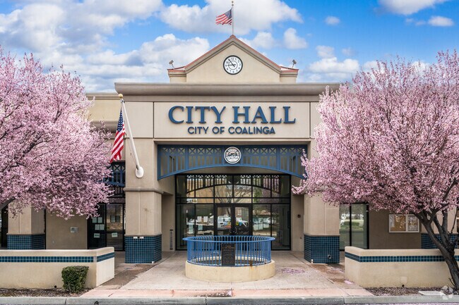 Pink blossomed trees highlight the City Hall in Coalinga.