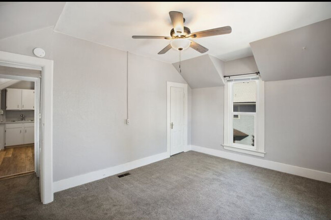 Living room view into kitchen, closet in corner. 10 ft ceilings - 318 E Colorado Ave