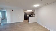 Located at 925 Finchley Pl in Richmond, Virginia, this single-floor residence offers a clean, contemporary layout designed for comfortable everyday living. The open-concept living area features light-toned laminate hardwood flooring that runs seamlessly from the entry through to the kitchen, creating a bright and cohesive feel throughout the main living space. A closet with louvered doors near the entry provides convenient storage.

The galley-style kitchen is efficiently designed with dark espresso cabinetry, granite-look countertops, a stainless steel sink, and black appliances including a refrigerator and electric range. A peninsula-style half-wall connects the kitchen to the living area, offering both functional workspace and an open sightline.

The bedrooms are carpeted and generously proportioned, each featuring large windows with blinds that invite natural light and offer views of the surrounding greenery. The neutral wall tones throughout create a calm, versatile backdrop.

The bathroom is finished with dark wood cabinetry, a granite-topped vanity, a large mirror, chrome fixtures, and a full tub-shower combination with clean white surround. Luxury vinyl plank flooring in the bathroom coordinates with the overall modern aesthetic. The unit presents a well-maintained, move-in-ready interior with consistent, thoughtful finishes throughout.