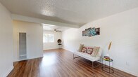 This 1-bedroom, 1-bathroom unit at 9012 Casals St in Sacramento, California offers a well-organized single-floor layout designed to maximize every square foot. The living room greets you with rich wood-style flooring, crisp white walls, a textured ceiling, and a ceiling fan, creating a bright and welcoming atmosphere. Natural light filters in through windows that offer pleasant outdoor views, enhancing the open feel of the space. A dedicated dining area flows seamlessly into the galley-style kitchen, which features gray cabinetry, warm-toned countertops, wood-style flooring, and white appliances including a refrigerator and range — offering a clean and functional cooking environment. The bedroom is a comfortable, carpeted retreat with its own ceiling fan, a window framing greenery outside, and access to a dedicated closet. The full bathroom is finished with matching gray cabinetry, a single vanity with a vessel-style sink, a mirror, a combined tub/shower, and a natural light window, all tied together with the same wood-style flooring found throughout the unit. A hallway connects all rooms efficiently. The overall design is clean, neutral, and move-in ready, making this unit a practical and comfortable home in Sacramento.