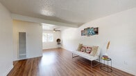This 1-bedroom, 1-bathroom unit at 9012 Casals St in Sacramento, California offers a well-organized single-floor layout designed to maximize every square foot. The living room greets you with rich wood-style flooring, crisp white walls, a textured ceiling, and a ceiling fan, creating a bright and welcoming atmosphere. Natural light filters in through windows that offer pleasant outdoor views, enhancing the open feel of the space. A dedicated dining area flows seamlessly into the galley-style kitchen, which features gray cabinetry, warm-toned countertops, wood-style flooring, and white appliances including a refrigerator and range — offering a clean and functional cooking environment. The bedroom is a comfortable, carpeted retreat with its own ceiling fan, a window framing greenery outside, and access to a dedicated closet. The full bathroom is finished with matching gray cabinetry, a single vanity with a vessel-style sink, a mirror, a combined tub/shower, and a natural light window, all tied together with the same wood-style flooring found throughout the unit. A hallway connects all rooms efficiently. The overall design is clean, neutral, and move-in ready, making this unit a practical and comfortable home in Sacramento.