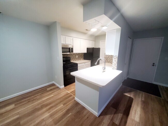 Kitchen with ample cabinet storage space on both sides. - 2275 Hedgerow Rd