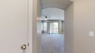 This 700 square foot apartment in Orlando, FL offers a harmonious blend of comfort and contemporary design. The open-concept living area is the heart of the home, featuring plush carpeting and ample natural light from large windows and sliding glass doors leading to a private balcony. The modern kitchen boasts white cabinetry, stainless steel appliances, and a convenient breakfast bar, perfect for casual dining or entertaining.

The spacious bedroom, measuring 170 square feet, includes a ceiling fan and adjoining closet for ample storage. The bathroom showcases a sleek design with a wood-look floor, white vanity, and a shower/tub combination. Throughout the apartment, neutral tones create a calming atmosphere, while ceiling fans ensure comfort year-round.

Additional features include built-in shelving in the living area, providing both storage and display space. The apartment's layout maximizes functionality, with a hallway connecting the main living spaces. This well-designed unit offers a perfect balance of style and practicality for modern urban living.