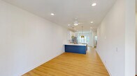 This four-story townhome at 2312 Ben Craig Dr in Charlotte, NC offers a well-organized layout across multiple levels, accommodating 2 bedrooms and 5 bathrooms with thoughtful use of space throughout. The exterior features classic siding with stone-accented steps, a bold front door, and neatly landscaped surroundings within a well-maintained residential community.

The ground level includes an attached garage with a clean, bright interior ideal for parking and storage. The main living floor hosts a combined kitchen and living area filled with natural light from large windows and a glass door opening to a private balcony with neighborhood views. The kitchen is outfitted with white shaker cabinets, quartz countertops, stainless steel appliances, a tile backsplash, and gold-accented pendant lighting and fixtures that add a contemporary touch.

The upper floors distribute the two bedrooms and multiple bathrooms across the remaining levels. The bedrooms feature warm hardwood-style flooring, natural light, and access to closet space. The bathrooms maintain a consistent, clean aesthetic with white cabinetry, framed mirrors, and light flooring. A top-floor loft-style space provides additional flexible living area. Connecting staircases and hallways tie each level together, creating a cohesive and functional multi-story home.
