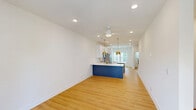 This four-story townhome at 2312 Ben Craig Dr in Charlotte, NC offers a well-organized layout across multiple levels, accommodating 2 bedrooms and 5 bathrooms with thoughtful use of space throughout. The exterior features classic siding with stone-accented steps, a bold front door, and neatly landscaped surroundings within a well-maintained residential community.

The ground level includes an attached garage with a clean, bright interior ideal for parking and storage. The main living floor hosts a combined kitchen and living area filled with natural light from large windows and a glass door opening to a private balcony with neighborhood views. The kitchen is outfitted with white shaker cabinets, quartz countertops, stainless steel appliances, a tile backsplash, and gold-accented pendant lighting and fixtures that add a contemporary touch.

The upper floors distribute the two bedrooms and multiple bathrooms across the remaining levels. The bedrooms feature warm hardwood-style flooring, natural light, and access to closet space. The bathrooms maintain a consistent, clean aesthetic with white cabinetry, framed mirrors, and light flooring. A top-floor loft-style space provides additional flexible living area. Connecting staircases and hallways tie each level together, creating a cohesive and functional multi-story home.