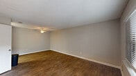 Located at 2310 W Cameo Ln in Knightdale, NC, this single-floor, 2-bedroom, 2-bathroom home offers a practical and well-appointed layout. The living room features rich, dark wood-style flooring, neutral gray walls, a textured ceiling, and a ceiling fan, creating a comfortable and welcoming atmosphere. Natural light flows in through windows fitted with blinds throughout the home.

The kitchen is a functional galley-style space outfitted with white shaker cabinets, granite-look countertops, a stainless steel sink, and stainless steel appliances including a range and refrigerator, complemented by light wood-style flooring.

Both bedrooms are carpeted with neutral tones and include windows that bring in natural light. The primary bedroom features a walk-in closet with built-in shelving. The second bedroom also offers closet access and a similarly comfortable feel.

The two bathrooms are clean and efficiently designed. One includes a single-sink vanity with white cabinetry, a framed mirror, and wood-style flooring. The second bathroom features a tub/shower combination with a curtain rod and light wood-style flooring. A hallway with additional closet storage connects the main areas of the home. The entry foyer, with its bold black front door, sets a welcoming tone upon arrival.