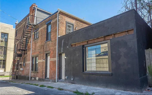 Back of property. Rooftop balcony spans above black area - 26 S Penn St