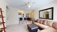 Located at 455 Ithaca Ct in Las Cruces, NM, this well-appointed single-story home offers a thoughtfully organized layout across one level. The open-concept living and kitchen area forms the heart of the home, featuring a breakfast bar with seating, light-toned countertops, warm wood cabinetry, and white appliances. A dedicated pantry closet provides additional storage convenience. The living room is bright and welcoming, with a ceiling fan, plush carpet, and a window that brings in natural light. Adjacent to the living space, the dining area accommodates an intimate round table beneath a pendant light fixture, adding a warm, inviting ambiance. The bedroom offers a comfortable retreat with soft carpet, ceiling fan, and ample room. The full bathroom is finished with tile flooring, a long vanity with wood cabinetry, and a shower-tub combination. A dedicated office space features rich dark-wood built-in shelving and desk cabinetry, ideal for remote work or study. The entryway is welcoming, with tile flooring and a decorative leaning shelf. In-unit laundry and an attached garage with automatic opener round out this functional and complete home.