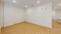 Located at 3311 Hood Ave in Chamblee, GA, this thoughtfully designed one-bedroom, one-bathroom unit offers a clean, modern aesthetic across a single floor. The open-concept layout seamlessly connects the kitchen, dining, and living areas, creating a bright and functional living space. The kitchen is a standout feature, showcasing gray shaker-style cabinetry, white quartz countertops, a large center island with a built-in sink, and a full suite of stainless steel appliances including a refrigerator, range, and microwave. Recessed lighting illuminates the space throughout. Light wood-look flooring runs continuously across all rooms, enhancing the airy, cohesive feel. The spacious living area benefits from large windows and a glass door that invite abundant natural light and views of the outdoors. The bedroom is a comfortable retreat equipped with a ceiling fan and a closet with double doors. Additional storage is provided by three closets throughout the unit, along with a dedicated laundry area. The bathroom is designed with accessibility in mind, featuring grab bars, a roll-in shower with white subway tile, and a clean, neutral finish. This well-appointed unit combines modern design with practical functionality.