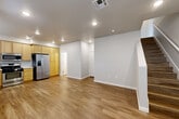 Located at 5121 Dowdell Ave in Rohnert Park, CA, this two-story home offers a well-organized layout spread across two floors. The main level houses a combined kitchen, dining, and living area that flows seamlessly together. The kitchen is equipped with light wood cabinetry, stainless steel appliances including a gas range, microwave, dishwasher, and a side-by-side refrigerator with ice and water dispenser, all complemented by light wood-style flooring throughout. A great room on the main floor provides additional living space, anchored by a staircase leading to the upper level. The ground floor also includes an attached garage with concrete flooring and direct interior access. Upstairs, the spacious primary bedroom features soft carpeting, natural light from a large window, and access to an outdoor area. The upper floor also includes a generously sized bathroom with a tub/shower combination enclosed by sliding glass doors, wood-tone vanity cabinetry, and wood-style flooring. Two additional bathrooms are present throughout the home. A dedicated laundry area and a closet round out the functional layout. Clean white walls, recessed lighting, and consistent wood-style flooring on the main level give the home a bright, modern, and cohesive aesthetic.
