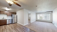 Located at 851 21st Ave SE in Rochester, MN, this 2-bedroom, 1-bathroom unit offers a practical and well-designed single-floor layout. The open-concept living and dining area features a seamless transition between durable wood-look vinyl flooring and plush carpeting, with a ceiling fan overhead and a large window that invites natural light and outdoor views. A baseboard heating system runs throughout the unit for consistent warmth.

The kitchen is efficiently designed with medium-toned wood cabinetry, light countertops, and a full suite of stainless steel appliances including a refrigerator, gas range, microwave, and dishwasher. The wood-look flooring continues through the kitchen, adding a cohesive feel.

Both bedrooms are carpeted and feature ceiling fans, natural light from windows, and baseboard heating. The primary bedroom is particularly notable for its generous closet space, with two sliding-door closets providing ample storage.

The bathroom is clean and functional, featuring a full tub-shower combination with built-in shelving, wood-tone cabinetry above, and wood-look flooring. Neutral tones and textured ceilings carry throughout the unit, creating a consistent and understated aesthetic well-suited for comfortable everyday living.
