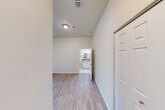 Located at 210 W Cross St in Ypsilanti, Michigan, this one-bedroom, one-bathroom unit offers a thoughtfully organized single-floor layout that maximizes every inch of its compact footprint. The open-concept living and dining area features light wood-style flooring and large windows fitted with blinds, allowing ample natural light to fill the space. A ceiling fan overhead adds comfort and airflow throughout.

The kitchen is well-equipped with white shaker-style cabinetry, laminate countertops, a stainless steel sink, a white electric range, and a full-size refrigerator. The layout provides generous counter and storage space relative to its size, with wood-style flooring continuing seamlessly from the adjoining living area.

The bedroom is carpeted for comfort and features large windows that bring in natural light, along with a ceiling fan and two closets for ample storage. The full bathroom is finished with tile flooring, a vanity with cabinet storage, a lighted mirror, and a tub/shower combination. Accessibility-friendly grab bars are installed near the tub and toilet, adding a practical and considerate touch.

A utility room and a hallway complete the layout, contributing to the unit's efficient and functional design throughout.