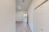 Located at 210 W Cross St in Ypsilanti, Michigan, this one-bedroom, one-bathroom unit offers a thoughtfully organized single-floor layout that maximizes every inch of its compact footprint. The open-concept living and dining area features light wood-style flooring and large windows fitted with blinds, allowing ample natural light to fill the space. A ceiling fan overhead adds comfort and airflow throughout.

The kitchen is well-equipped with white shaker-style cabinetry, laminate countertops, a stainless steel sink, a white electric range, and a full-size refrigerator. The layout provides generous counter and storage space relative to its size, with wood-style flooring continuing seamlessly from the adjoining living area.

The bedroom is carpeted for comfort and features large windows that bring in natural light, along with a ceiling fan and two closets for ample storage. The full bathroom is finished with tile flooring, a vanity with cabinet storage, a lighted mirror, and a tub/shower combination. Accessibility-friendly grab bars are installed near the tub and toilet, adding a practical and considerate touch.

A utility room and a hallway complete the layout, contributing to the unit's efficient and functional design throughout.