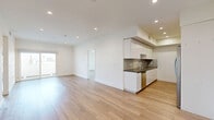 Located in the vibrant Koreatown neighborhood of Los Angeles, this well-appointed 3-bedroom, 1-bathroom residence offers a clean, contemporary aesthetic throughout its single-floor layout. Light-toned hardwood-style flooring flows seamlessly through every room, complementing the crisp white walls and recessed lighting that give the home a bright, open feel.

The open-concept living and dining area connects effortlessly to a sleek, modern kitchen featuring floor-to-ceiling white cabinetry, dark quartz countertops, stainless steel appliances including a gas range, dishwasher, and refrigerator, and a striking herringbone-patterned tile backsplash. A tray ceiling detail adds architectural interest overhead.

The spacious primary bedroom includes a mirrored sliding closet and ample room for furnishings, while two additional bedrooms offer flexible use as guest rooms or a home office. Three closets provide generous storage throughout. The full bathroom is finished with large-format floor tiles, a combined tub and shower with sliding glass doors, a white vanity with dark countertop, and a framed mirror.

Additional highlights include an in-unit laundry area, a private patio, and a bold black front entry door. The home presents a cohesive modern design ideal for comfortable urban living.