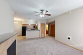Located at 1016 Haeffele Way in Bloomington, Illinois, this well-appointed one-bedroom, one-bathroom unit offers a thoughtfully designed single-floor layout. The open-concept living and dining area is finished with plush carpeting and a ceiling fan with integrated lighting, creating a comfortable and airy atmosphere. A gas fireplace adds a warm focal point to the living space.

The kitchen is a standout feature, equipped with warm-toned wooden cabinetry, dark granite-style countertops, and black appliances including a refrigerator, range, and built-in microwave. A peninsula with pendant lighting and bar seating connects the kitchen to the dining area, making it ideal for both cooking and entertaining. Light ceramic tile flooring completes the kitchen's clean, functional aesthetic.

The bedroom is a generously sized retreat with soft carpeting and a ceiling fan. It features access to a large walk-in closet with wire shelving and hanging rods, along with two additional closets providing ample storage throughout the unit.

The full bathroom includes a tiled floor, a vanity with granite-style countertop, and a tub/shower combination. A dedicated laundry area and utility room add everyday convenience. The hallway provides a smooth flow between all rooms, rounding out this practical and comfortable home.