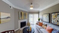 Located at 5530 Sun Pass Dr in Indianapolis, IN, this single-floor residence offers a well-designed layout with cohesive finishes throughout. The open-concept living and dining area is anchored by a tile-surround fireplace and features wood-style plank flooring, crown molding, and a sliding glass door that fills the space with natural light. A pendant light fixture adds a decorative touch to the dining area, which flows seamlessly from the kitchen.

The galley-style kitchen is outfitted with white shaker cabinetry, granite countertops, a stainless steel double sink, and black appliances including a refrigerator, range, and built-in microwave. The layout maximizes functionality while maintaining a clean, modern aesthetic.

Two well-proportioned bedrooms provide comfortable retreats, each with warm neutral wall tones and plush carpet flooring. The primary bedroom benefits from natural light through large windows dressed with sheer curtains and blinds. Two full bathrooms complement the bedrooms, each featuring tiled tub-shower combinations, granite-topped vanities, and wood-style flooring. Crown molding is carried throughout the main living spaces, lending a polished finish to the overall interior design.