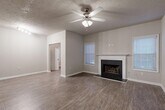Located in Atlanta's Lenox Park neighborhood, this well-appointed 2-bedroom, 2-bathroom single-floor residence offers a thoughtfully designed layout with a variety of functional spaces. Wood-look flooring flows throughout the main living areas, complemented by neutral tones and clean white trim throughout.

The open living and dining area serves as the heart of the home, anchored by a classic fireplace with a white mantle surround and flanked by windows with blinds that invite natural light. A ceiling fan overhead adds comfort to this generously sized gathering space. An additional den provides flexibility for a home office or secondary lounge.

The galley-style kitchen features white cabinetry, light stone countertops, a stainless steel dishwasher, and ample prep space along both sides, connecting seamlessly to the rest of the home.

The primary bedroom is spacious and carpeted, with a ceiling fan and access to its own bathroom. The bathrooms are finished with wood-look flooring, white cabinetry, and tub/shower combinations. Eight closets throughout the residence provide exceptional storage. A dedicated laundry area and utility room add everyday convenience. Hallways connect each area smoothly, creating a cohesive and practical floor plan.