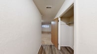 Located at 1819 N 5th St in Niles, Michigan, this two-bedroom, one-bathroom unit offers a practical and well-organized single-floor layout. The galley-style kitchen is efficiently designed with warm oak cabinetry lining both walls, providing ample upper and lower storage. White appliances, including a coil-burner range, refrigerator, and overhead ventilation hood, complement the light countertops and stainless steel double-basin sink, all set atop durable hardwood-style flooring.

Connecting hallways lead to two carpeted bedrooms, each featuring neutral tones and natural light from horizontal windows. The primary bedroom is generously sized and includes dual closets with built-in shelving and hanging rods, offering excellent storage capacity. A ceiling fan with integrated lighting adds comfort to the second bedroom. Both rooms share a clean, understated aesthetic with smooth white walls and textured ceilings.

The full bathroom is equipped with a shower-tub combination featuring a molded surround. Hardwood-style flooring flows through the entry and hallway areas, transitioning to plush carpet in the bedrooms. The overall layout is functional and straightforward, making efficient use of the available space throughout the unit.