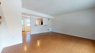 Located at 44 Craig Ave in Madison, WI, this two-floor space offers a well-organized layout with distinct living areas spread across both levels. The main level showcases warm bamboo-style hardwood flooring throughout, lending a cohesive and inviting aesthetic to the open living area. A defining architectural feature is the pass-through kitchen opening, complete with a breakfast bar ledge, which connects the kitchen to the main living space while maintaining a sense of separation. The kitchen itself is well-appointed with warm wood cabinetry, granite-style countertops, and stainless steel appliances including a refrigerator, range, microwave, and dishwasher. A half bathroom on the main level features matching hardwood flooring, a wood-toned vanity, and a window that draws in natural light. The upper level transitions to plush carpeted flooring and includes generously sized bedrooms, one of which features two closets. A full bathroom on this level is finished with tile flooring, a wood vanity, large mirror, and a walk-in shower. Windows throughout the upper level provide views of the surrounding greenery, enhancing the overall sense of comfort and connection to the outdoors.