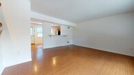 Located at 44 Craig Ave in Madison, WI, this two-floor space offers a well-organized layout with distinct living areas spread across both levels. The main level showcases warm bamboo-style hardwood flooring throughout, lending a cohesive and inviting aesthetic to the open living area. A defining architectural feature is the pass-through kitchen opening, complete with a breakfast bar ledge, which connects the kitchen to the main living space while maintaining a sense of separation. The kitchen itself is well-appointed with warm wood cabinetry, granite-style countertops, and stainless steel appliances including a refrigerator, range, microwave, and dishwasher. A half bathroom on the main level features matching hardwood flooring, a wood-toned vanity, and a window that draws in natural light. The upper level transitions to plush carpeted flooring and includes generously sized bedrooms, one of which features two closets. A full bathroom on this level is finished with tile flooring, a wood vanity, large mirror, and a walk-in shower. Windows throughout the upper level provide views of the surrounding greenery, enhancing the overall sense of comfort and connection to the outdoors.
