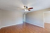 Located at 2070-2080 Hazel Avenue in Beaumont, Texas, this single-story 2-bedroom, 1-bathroom home offers a functional and comfortable layout across one level. The living room welcomes you with warm wood-look flooring, neutral gray walls, a textured ceiling, and a ceiling fan with light kit. A large window floods the space with natural light and provides views of the surrounding neighborhood. The open dining area flows directly from the kitchen, which features white cabinetry, granite-style countertops, stainless steel appliances including a dishwasher, microwave, and range, along with recessed lighting and matching wood-look floors. Both bedrooms are finished with plush carpet, ceiling fans, and double-door closets, offering a quiet and comfortable retreat. The spacious primary bedroom includes its own closet access. The full bathroom is thoughtfully designed with large-format tile surround, a mosaic accent border, a soaking tub with shower, and brushed nickel fixtures. A dedicated laundry area accommodates a full-size washer and dryer. With five closets throughout, this home provides generous storage for everyday living.